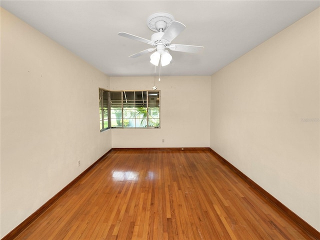 empty room with hardwood / wood-style floors and ceiling fan