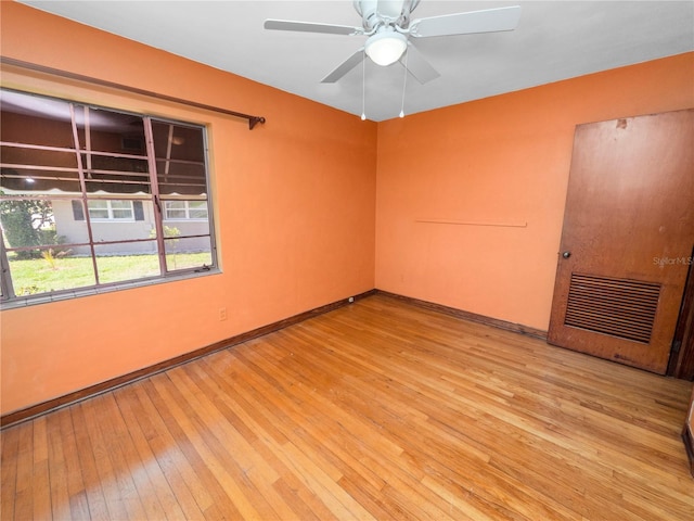 spare room featuring light hardwood / wood-style floors and ceiling fan