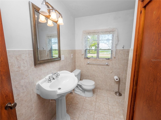 bathroom featuring tile patterned floors, tile walls, and toilet