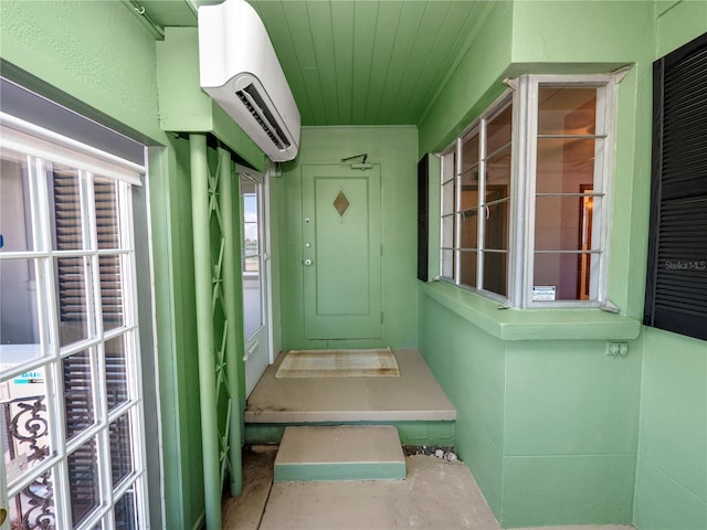 property entrance featuring a wall mounted air conditioner