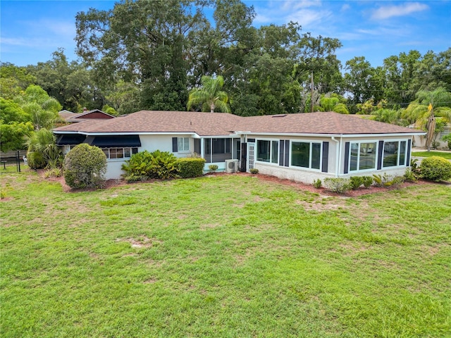 ranch-style house featuring a sunroom, cooling unit, and a front yard