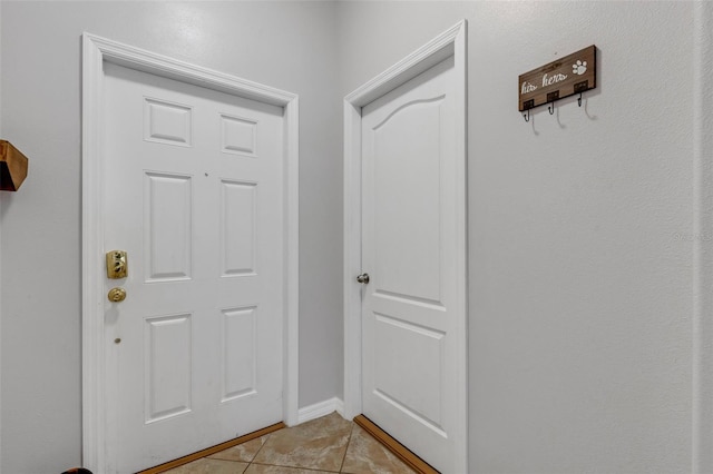 entryway with light tile patterned flooring