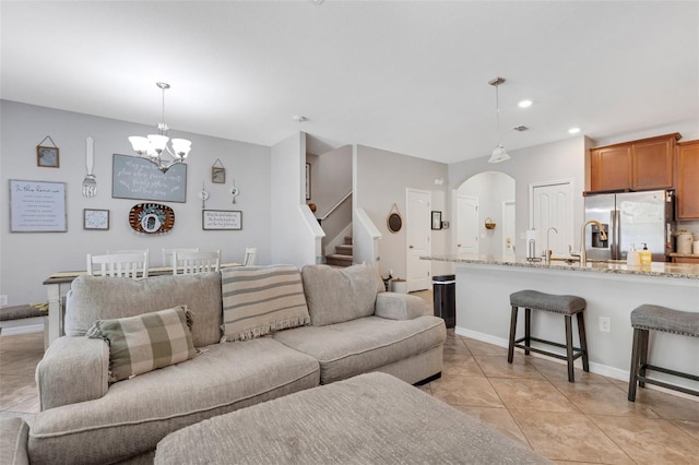 living room featuring a notable chandelier and light tile patterned floors