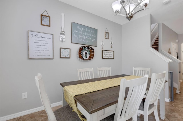 tiled dining room featuring a chandelier