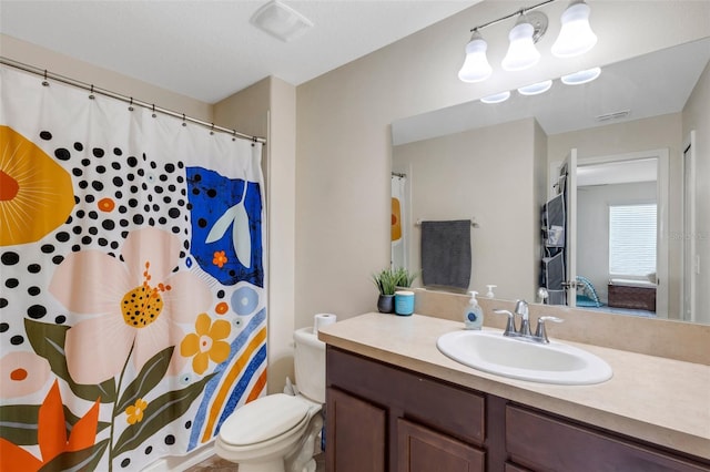 bathroom with toilet and vanity