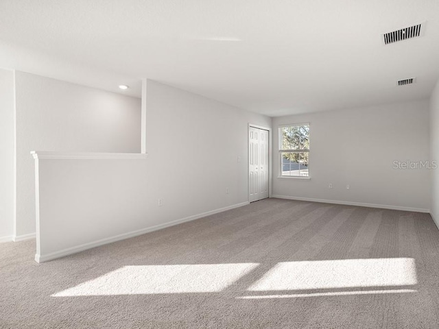 unfurnished room featuring light colored carpet