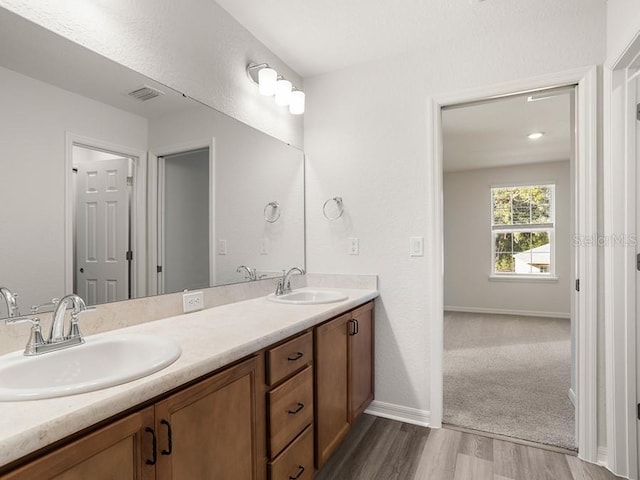 bathroom with vanity and hardwood / wood-style flooring