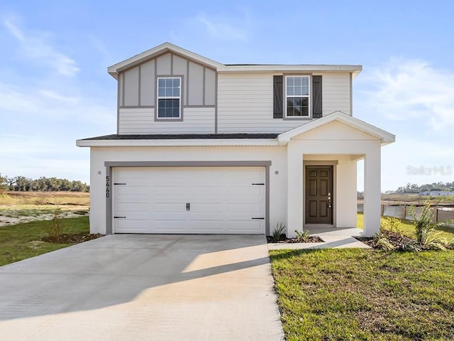 view of front facade featuring a front yard and a garage