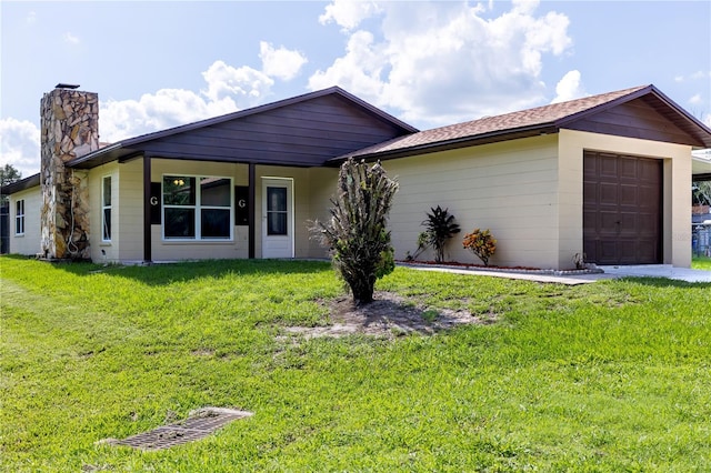 ranch-style home with a front lawn and a garage