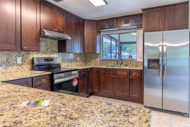 kitchen featuring appliances with stainless steel finishes, light stone counters, sink, and light tile patterned floors