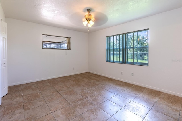 unfurnished room with ceiling fan