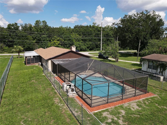 view of pool featuring a lanai and a yard