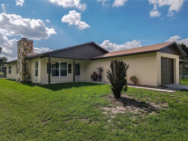 view of front of property with a garage and a front lawn