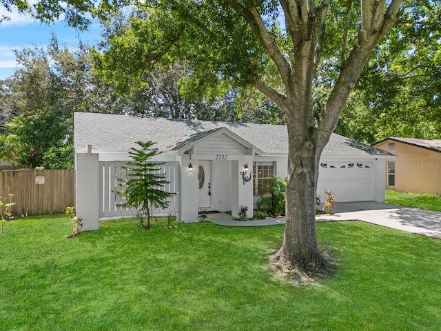 single story home with a garage and a front lawn