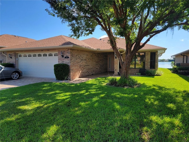 ranch-style home with a garage, driveway, brick siding, and a front lawn