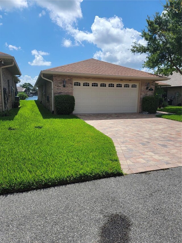 view of front of home featuring a garage and a front lawn