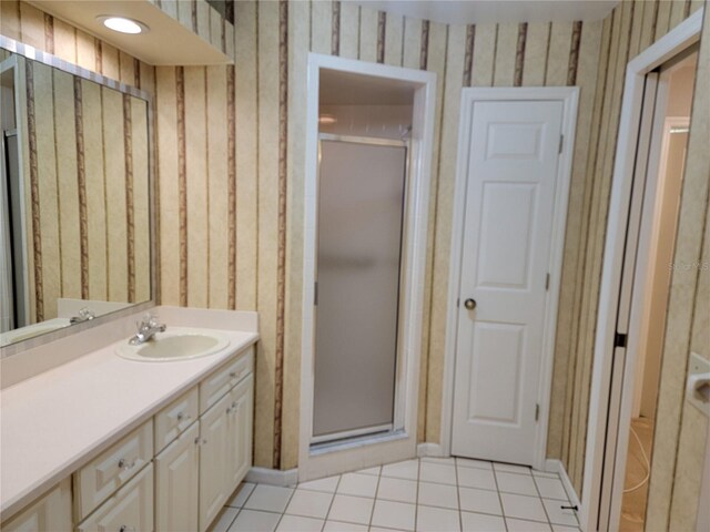 bathroom with tile patterned flooring, vanity, and a shower with shower door