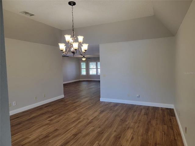 unfurnished room with dark hardwood / wood-style flooring, ceiling fan with notable chandelier, and lofted ceiling