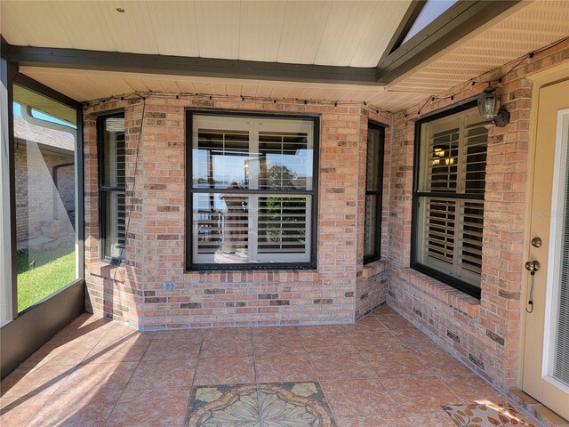 exterior space with lofted ceiling with beams