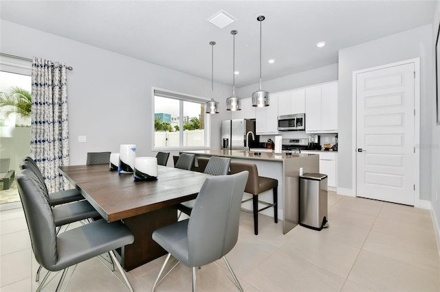 dining area with light tile patterned floors and sink