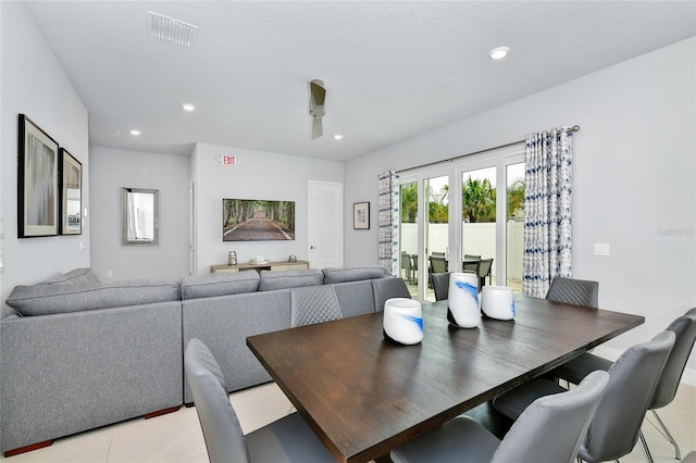 dining area with ceiling fan and light tile patterned flooring