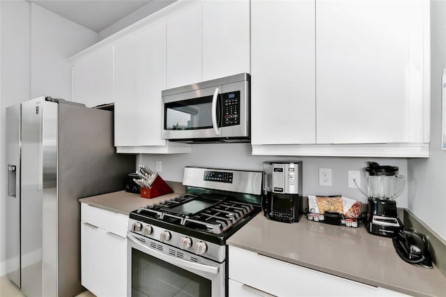 kitchen with white cabinets and appliances with stainless steel finishes