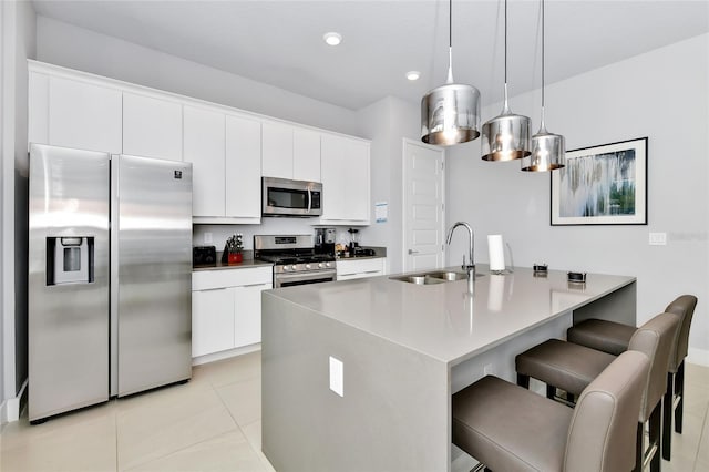 kitchen with sink, white cabinets, and stainless steel appliances