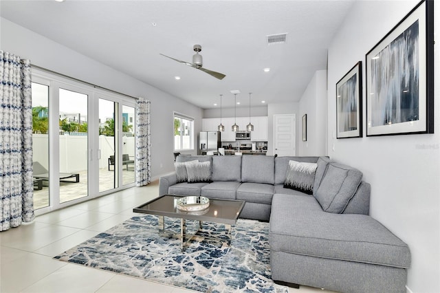 living room with tile patterned flooring and ceiling fan