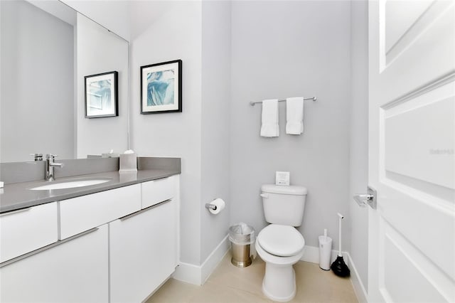 bathroom featuring tile patterned floors, vanity, and toilet