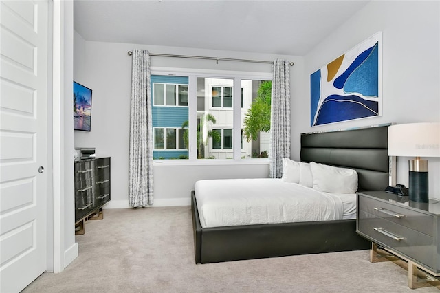 carpeted bedroom featuring multiple windows