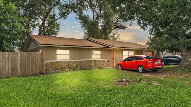 1612 High Point Ct SW, Winter Haven, FL 33880 - view of front facade with a front lawn, fence, and stone siding
