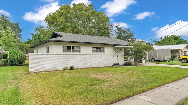 ranch-style home with a front lawn