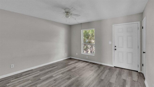 empty room featuring ceiling fan and hardwood / wood-style floors