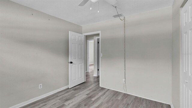 unfurnished bedroom featuring ceiling fan and light hardwood / wood-style floors