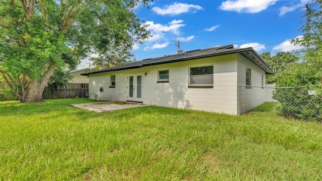 back of house with a yard and a patio area