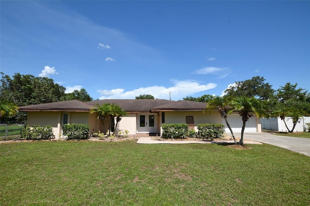 ranch-style house featuring a garage and a front lawn