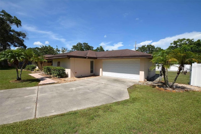 view of front of home with a front lawn and a garage