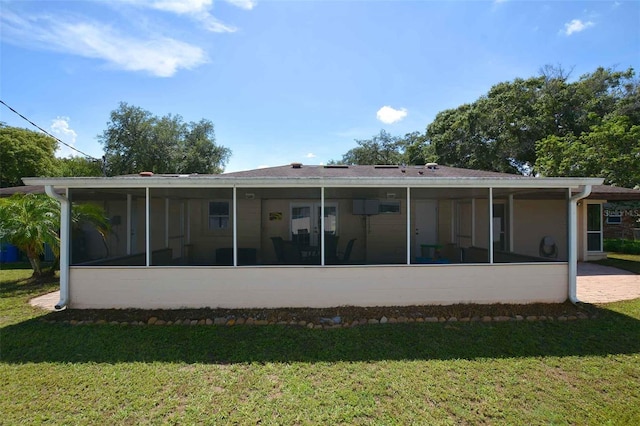 back of house featuring a sunroom and a yard