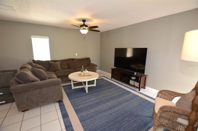 living room featuring ceiling fan and light tile patterned flooring