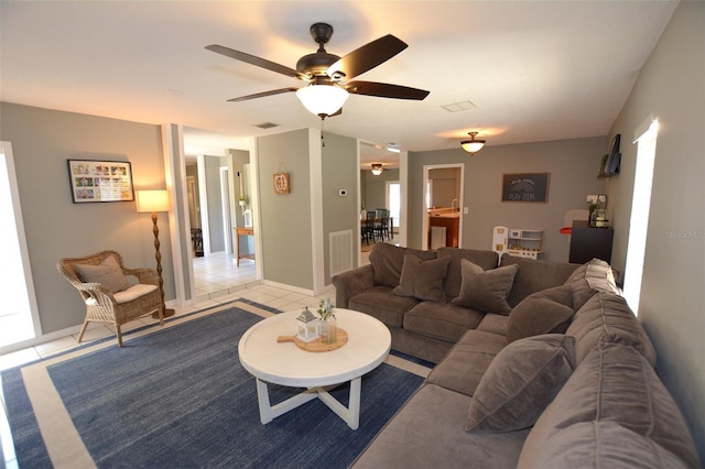 tiled living room with ceiling fan