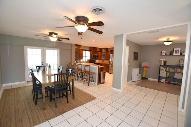 dining area with ceiling fan, light tile patterned flooring, and french doors