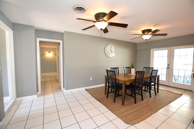 tiled dining space featuring french doors and ceiling fan