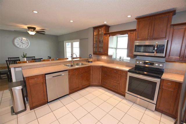 kitchen with ceiling fan, sink, stainless steel appliances, and a wealth of natural light