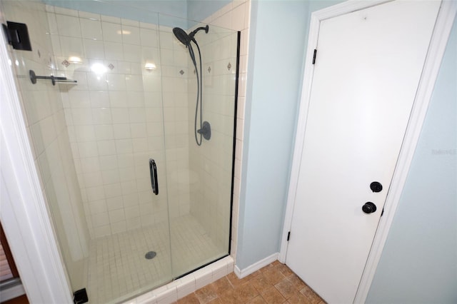 bathroom featuring tile patterned floors and a shower with shower door