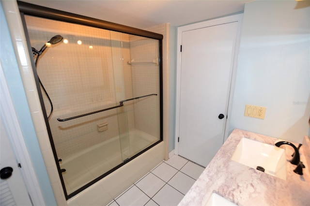 bathroom with tile patterned floors, vanity, and bath / shower combo with glass door