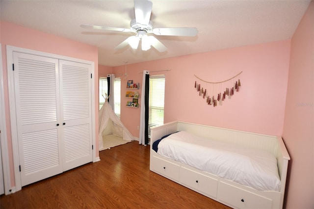 bedroom featuring a closet, ceiling fan, and dark wood-type flooring