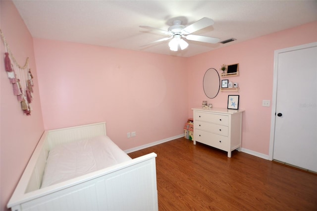 bedroom featuring dark hardwood / wood-style flooring and ceiling fan