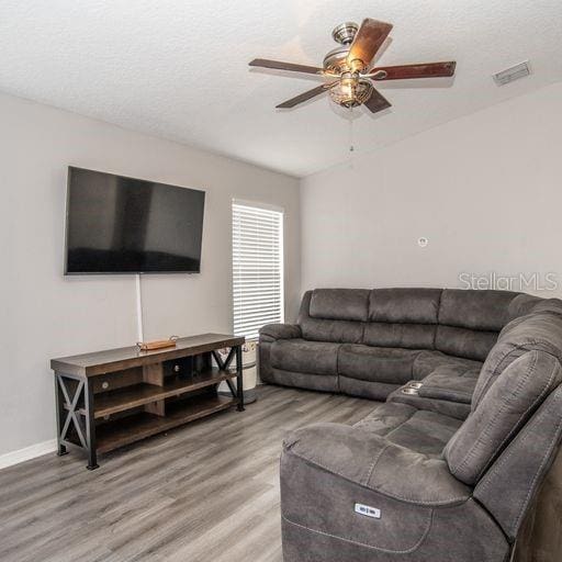 living room with hardwood / wood-style flooring and ceiling fan