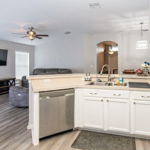 kitchen featuring white cabinets, pendant lighting, stainless steel dishwasher, and sink