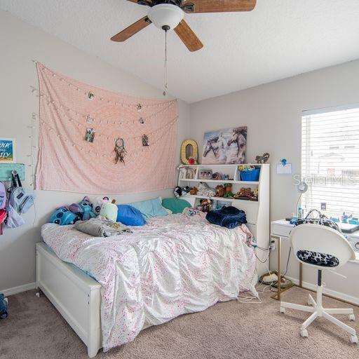 carpeted bedroom with ceiling fan